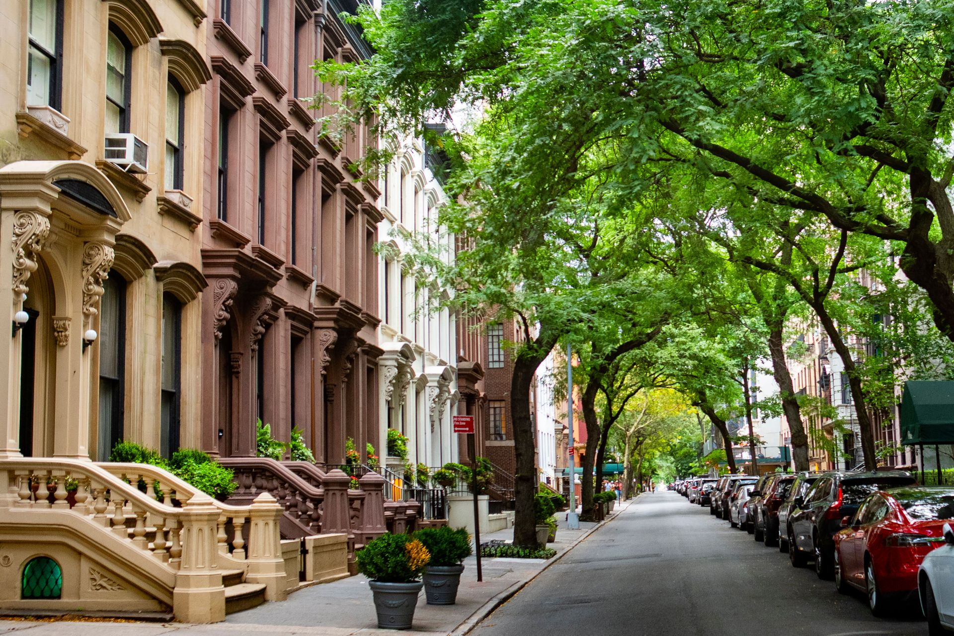 Tree-lined residential street with brownstone homes in Manhattan, New York City